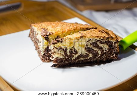 Delicious Homemade Chocolate Cake With Cottage Cheese On The White Background. A Piece Is Cut Out Of