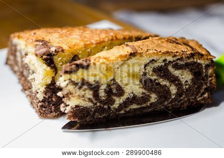 Delicious Homemade Chocolate Cake With Cottage Cheese On The White Background. A Piece Is Cut Out Of