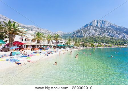 Gradac, Dalmatia, Croatia, Europe - August 24, 2017 - Several Tourists Bathing And Relaxing At The B