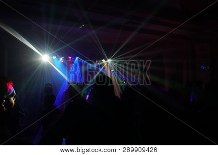 Crowd Of People Dancing Under Disco Laser Light