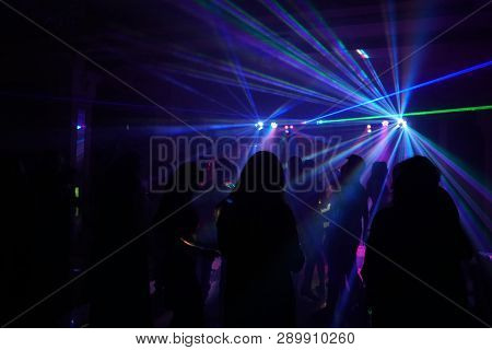 Crowd Of People Dancing Under Disco Laser Light