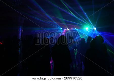 Crowd Of People Dancing Under Disco Laser Light