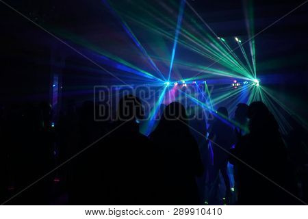 Crowd Of People Dancing Under Disco Laser Light