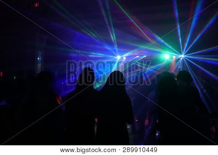 Crowd Of People Dancing Under Disco Laser Light