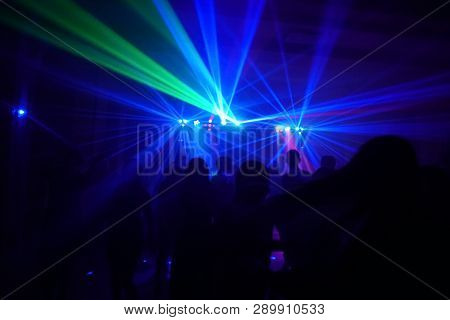 Crowd Of People Dancing Under Disco Laser Light