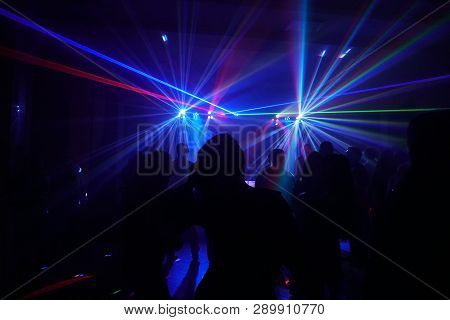 Crowd Of People Dancing Under Disco Laser Light