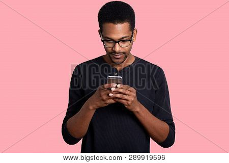 Handsome Black Man Wears Optical Glasses, Recives Important News From Friend. Young African Man Hold