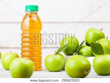 Bottle Of Fresh Organic Apple Juice With Granny Smith And British Bramley Apples In Box On Wooden Ba