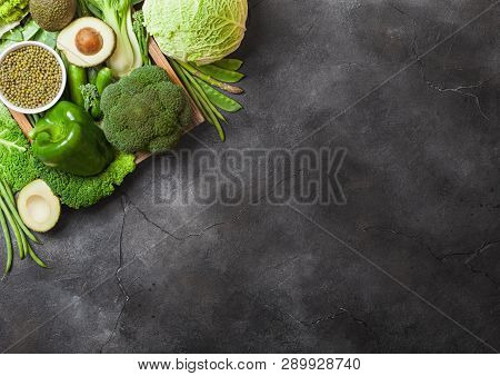 Assorted Green Toned Raw Organic Vegetables On Dark Background. Avocado, Cabbage, Broccoli, Cauliflo