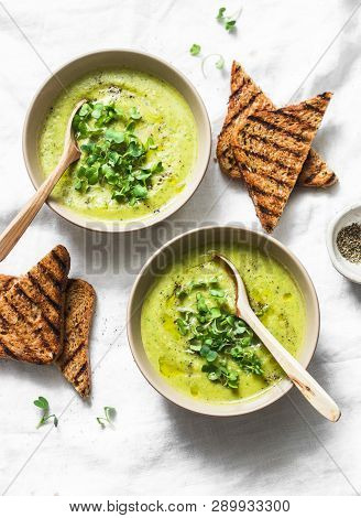 Mashed Spring Vegetable Soup Served With Micro Greens And Whole Grain Crackers On A Light Background