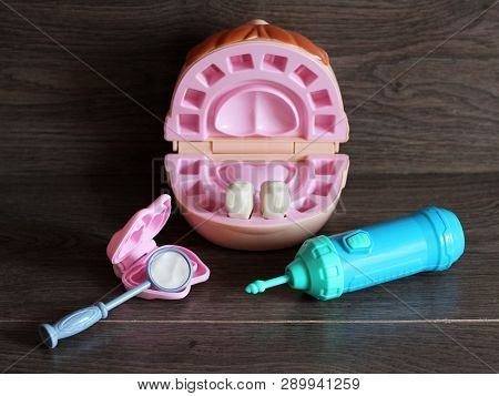 Teeth Model With Dental Tools, Toys On Wooden Background