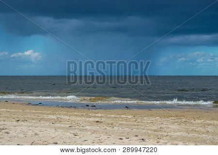 Dark Rain Clouds Above The Baltic Sea. Raining.