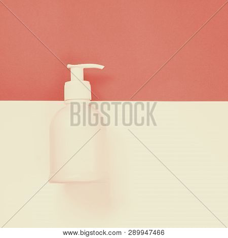 White Plastic Dispenser Mock Up Bottle On The Empty Devided Into Two Parts Background With Copy Spac