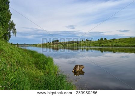 Reflection Of Meadow In Still River At Summer Relax