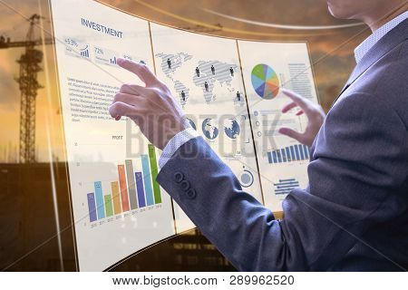 Businessman In Front Of Modern Virtual Touch Screen Analysing On Investment Risk Management And Retu