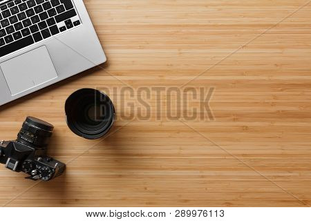 Photographer Bamboo Desk Table With Film Camera, Laptop Computer And Supplies. Top View, Flat Lay, C
