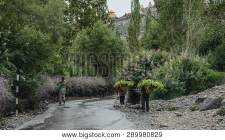 Tibetan People Walking On Rural Road
