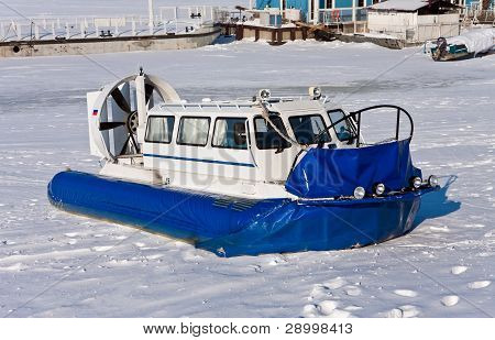 Hovercraft che attraversano il fiume ghiacciato contro un cielo blu