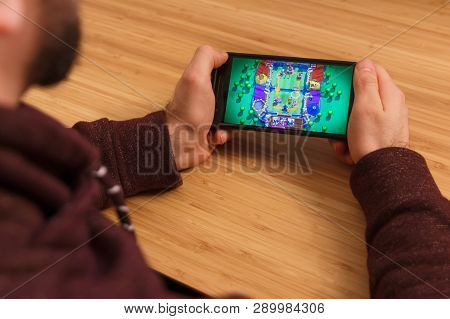Prague, Czech Republic - March 16, 2019: Man Holding A Smartphone And Playng The Clash Royale Mobile