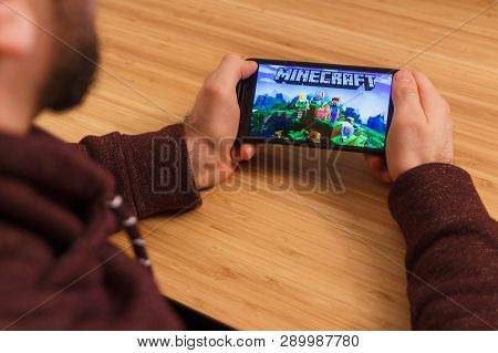 Prague, Czech Republic - March 16, 2019: Man Holding A Smartphone And Playng The Minecraft Mobile Ga