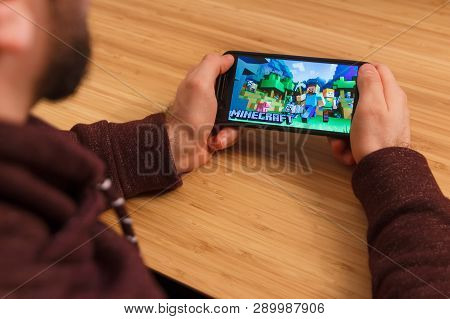 Prague, Czech Republic - March 16, 2019: Man Holding A Smartphone And Playng The Minecraft Mobile Ga