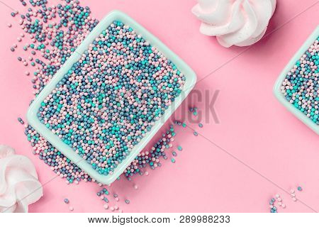 Colorful Nonpareils Cake Candy Sprinkles In Two White Rectangular Bowls And Cookies On Pink Backgrou