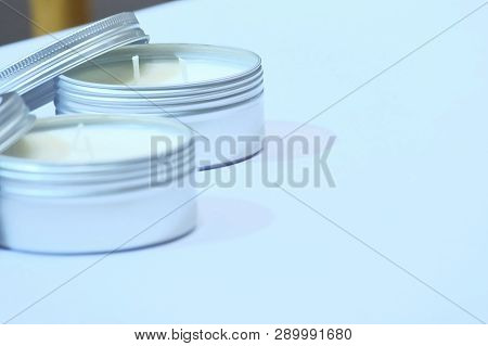 In Selective Focus Of A White Candle In A Steel Box Packaging And Showing On White Table