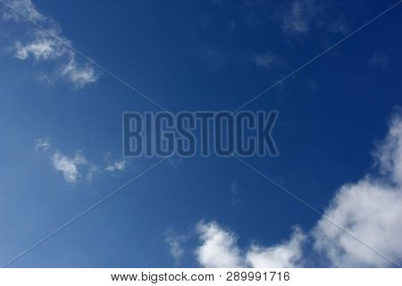 Blue Sky Background With Clouds And Sun Light