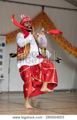 Columbus, Ohio, USA - May 27, 2018  A group of Bhangra dancers perform at the Asian Festival and the public join them in the dancing.