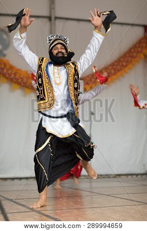 Columbus, Ohio, USA - May 27, 2018  A group of Bhangra dancers perform at the Asian Festival and the public join them in the dancing.
