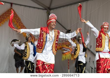 Columbus, Ohio, USA - May 27, 2018  A group of Bhangra dancers perform at the Asian Festival and the public join them in the dancing.