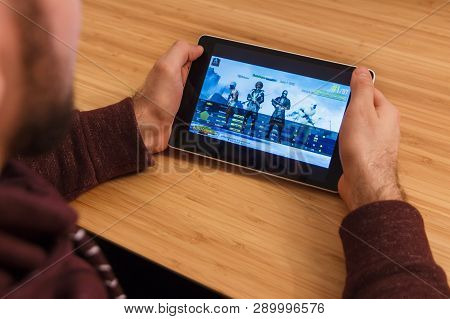 Prague, Czech Republic - March 16, 2019: Man Holding A Smartphone And Playng The Playerunknown S Bat