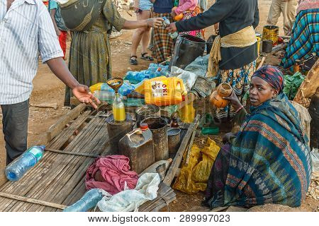 Chencha, Ethiopia - December 05, 2013: Ethiopian Woman Selling Oil At A Local Market.