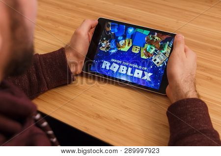 Prague, Czech Republic - March 16, 2019: Man Holding A Smartphone And Playng The Roblox Mobile Game.