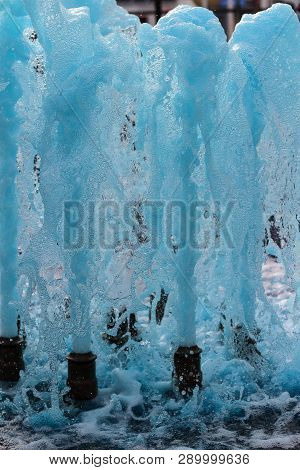 Foreground In Vertical View Of A Source Expelling Blue Water