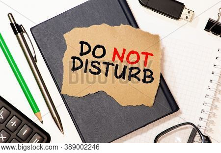 Text Do Not Disturb On Short Note Paper On The Packing Paper Box Texture Background.
