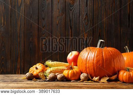 Composition With Vegetables, Nuts And Autumn Leaves On Wooden Table, Space For Text. Thanksgiving Da