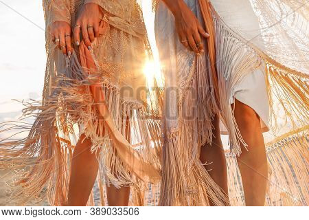 Two Beautiful Young Woman In Elegant Boho Dresses Oudoors At Sunset