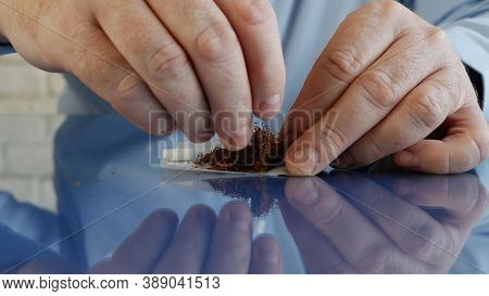 Smoker Roll A Handmade Cigarette Using Cigarette Paper A Filter And Tobacco