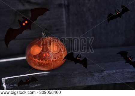 Helloween Pumpkin With Bats On Black Background. Big Spooky Helloween Symbol. Front View. Selective 