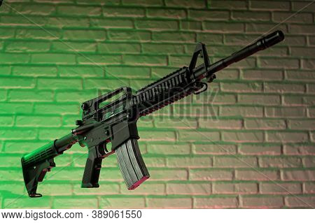 American Army Rifle M4a1 Against A Brick Wall