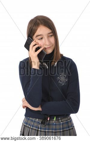 Pre-adolescent Girl Called On Black Smartphone. Isolated On White Background. High Resolution Photo.