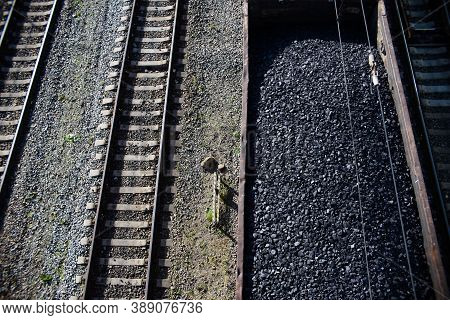 Coal Wagon On The Railroad, Top View. Rails, Train With Raw Materials