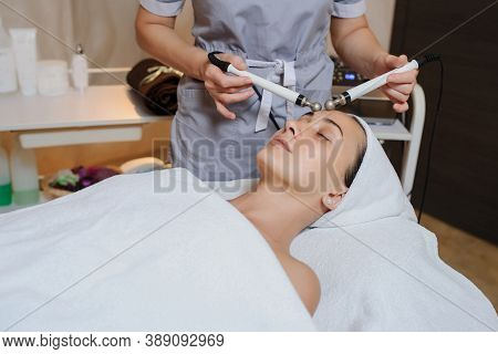 Lateral View Of Woman Facial Massage Spa Procedure. Electric Stimulation Facial Skin Care. Microcurr