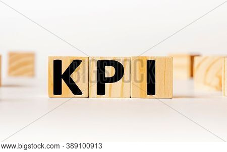 A Wooden Block With The Word Kpi Key Performance Indicator Written On It On A White Background. Busi