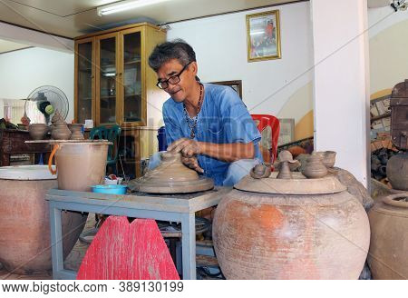 Nonthaburi, Thailand - July 29, 2017 :  Clay Potter Joyfully To Molding Pottery From Clay On The Rot