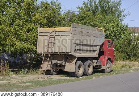 Nikolaev, Ukraine - September 21, 2020: Kamaz Dump Truck Stands On The Side Of The Road. Ladder At T