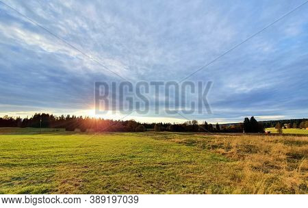 Beautiful Sunset Over Meadow And Forest Near Kvilda Village In Sumava National Park Landscape.