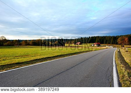 Country Road Near Kvilda Village Between Meadows In Sumava National Park With Beautiful Sunset Light