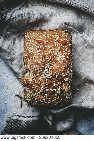 Whole Wheat Organic Rye Dark Bread With Pumpkin Seeds, Dried Fruit, Raisins And Sesame Seeds On Gray
